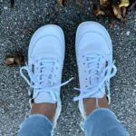 Wide toe box sneakers worn outdoors on pavement