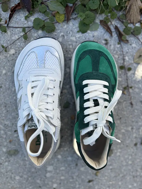 Two pairs of sneakers side by side, one blue and one green.