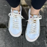 White barefoot sneakers with subtle color accents, top-down view