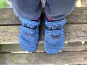 Blue kids barefoot sneakers worn outdoors, top view
